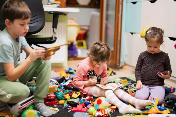 Photo of three kids playing together.